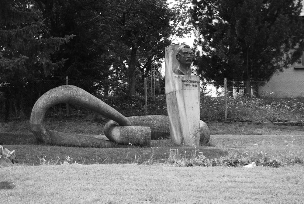 a statue of a person holding a surfboard in a yard