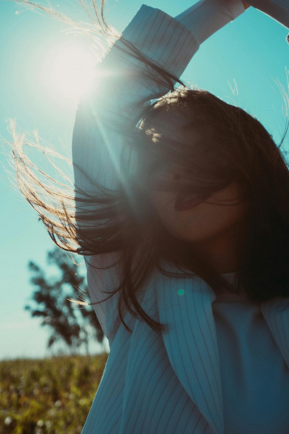 a woman with her hair blowing in the wind