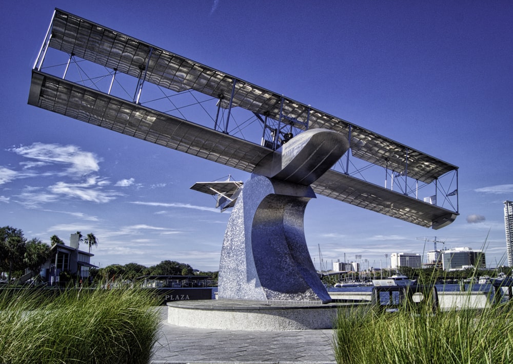 a sculpture of an airplane is in the grass