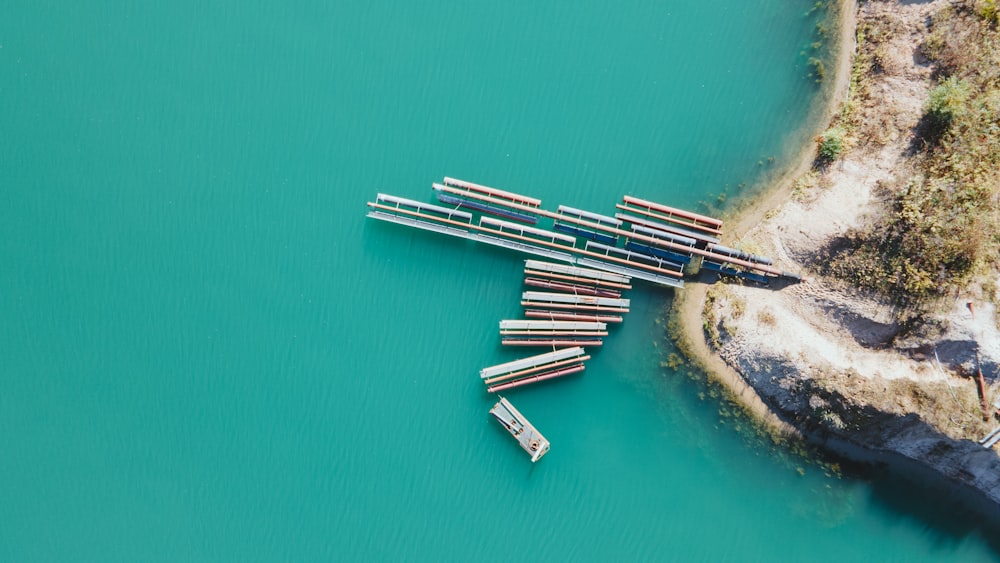 a group of logs sitting in the middle of a body of water