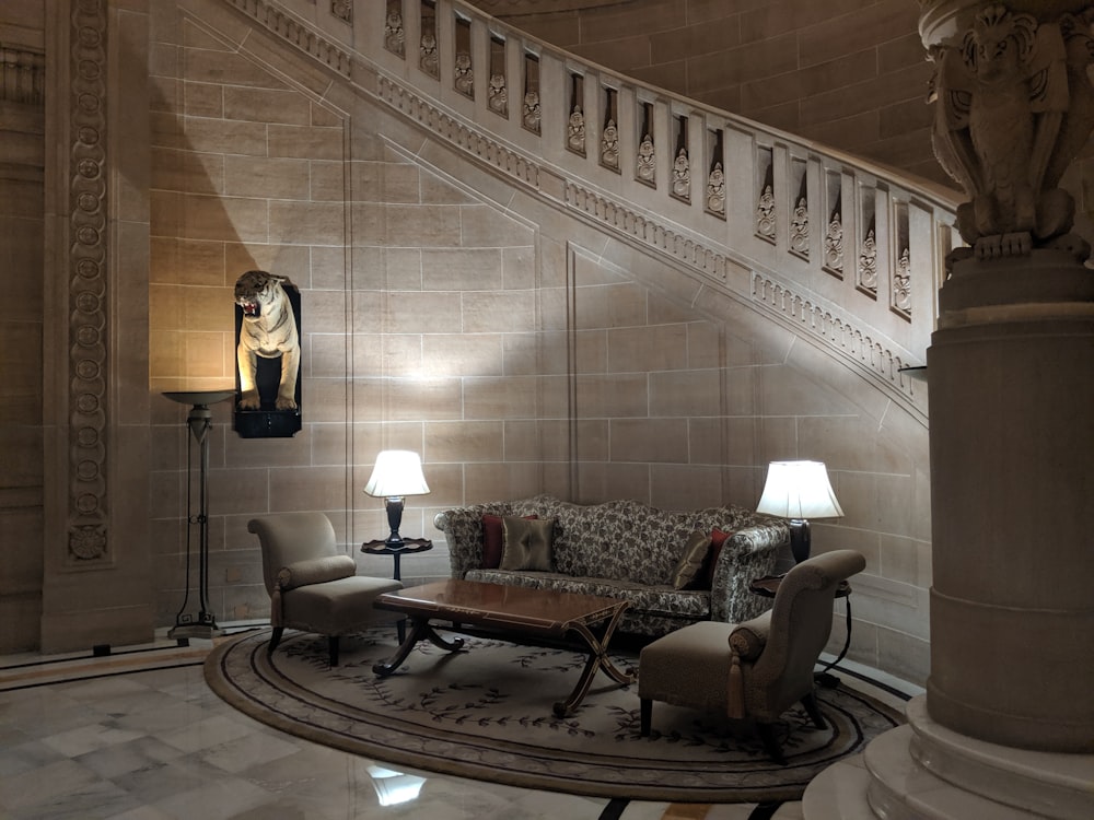 a living room with a couch a chair and a lamp