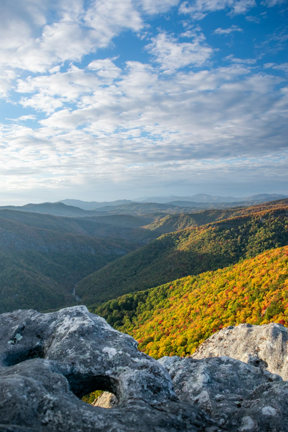 a scenic view of a valley in the mountains