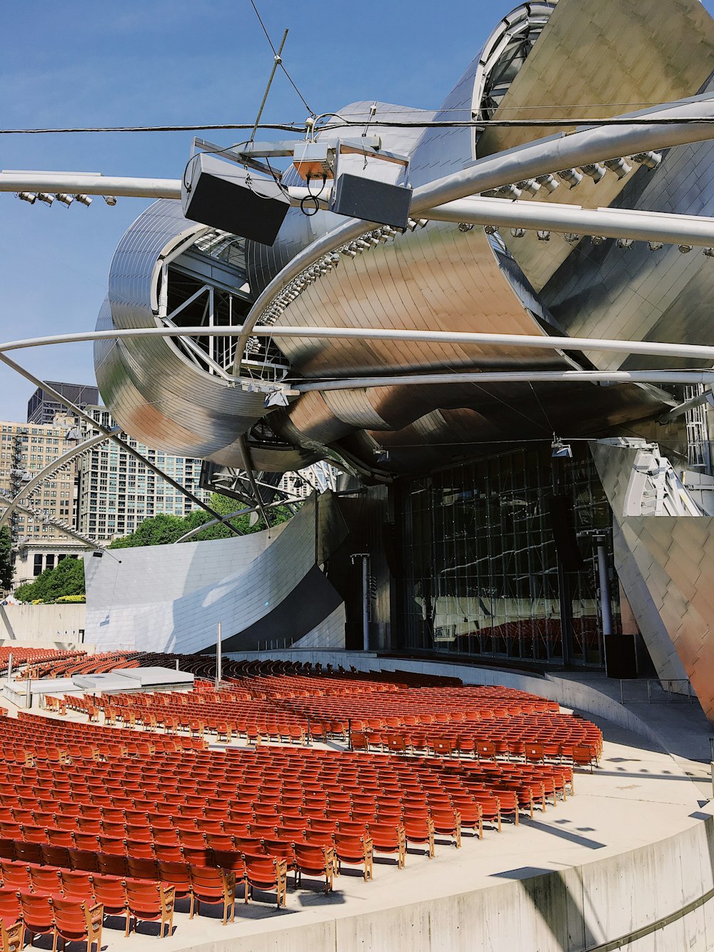 a large auditorium with rows of red seats