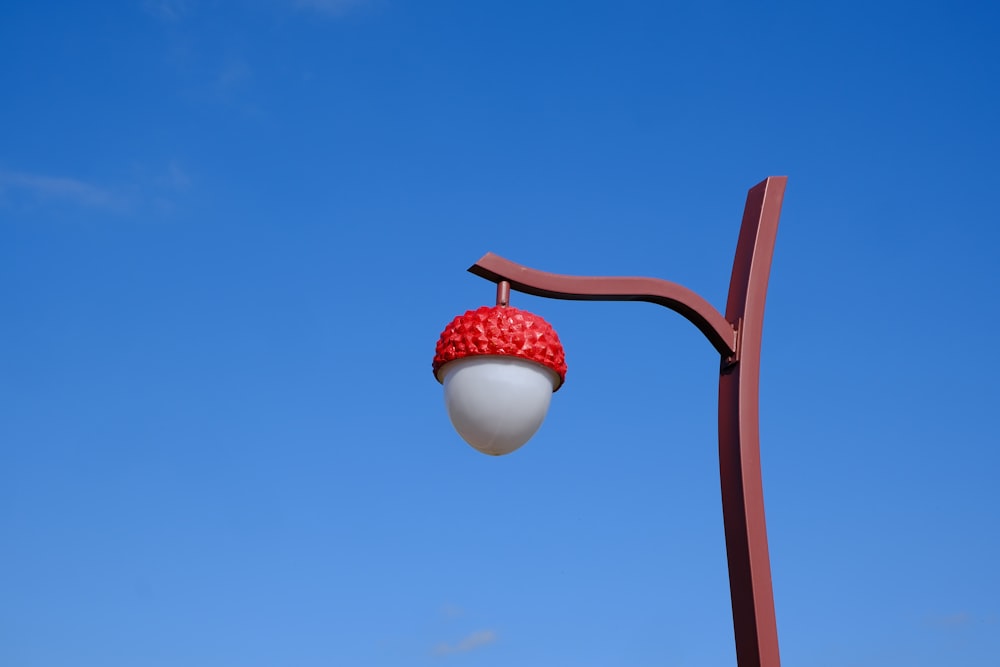 a street light with a strawberry on top of it