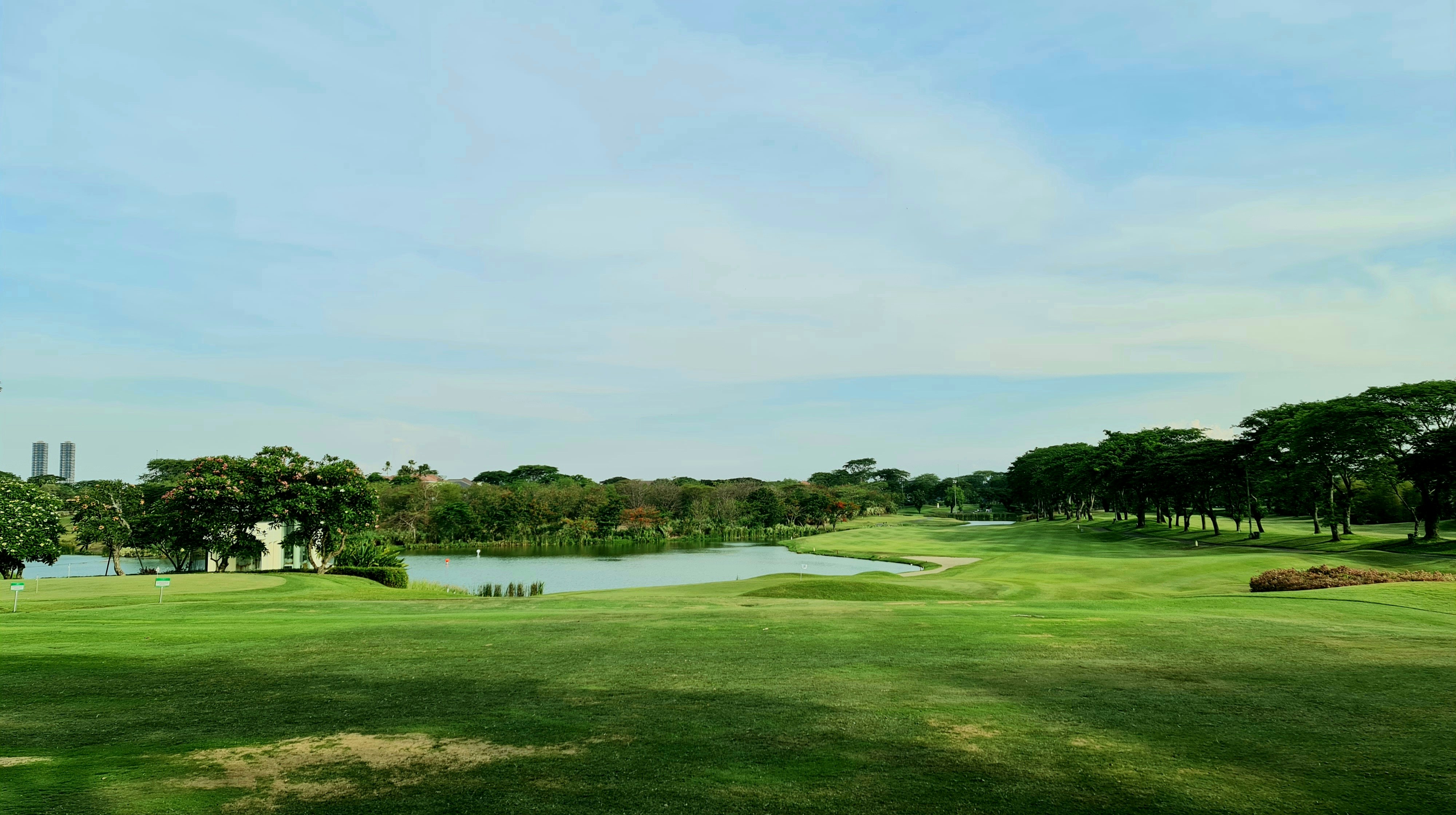 a view of a golf course with a lake in the background