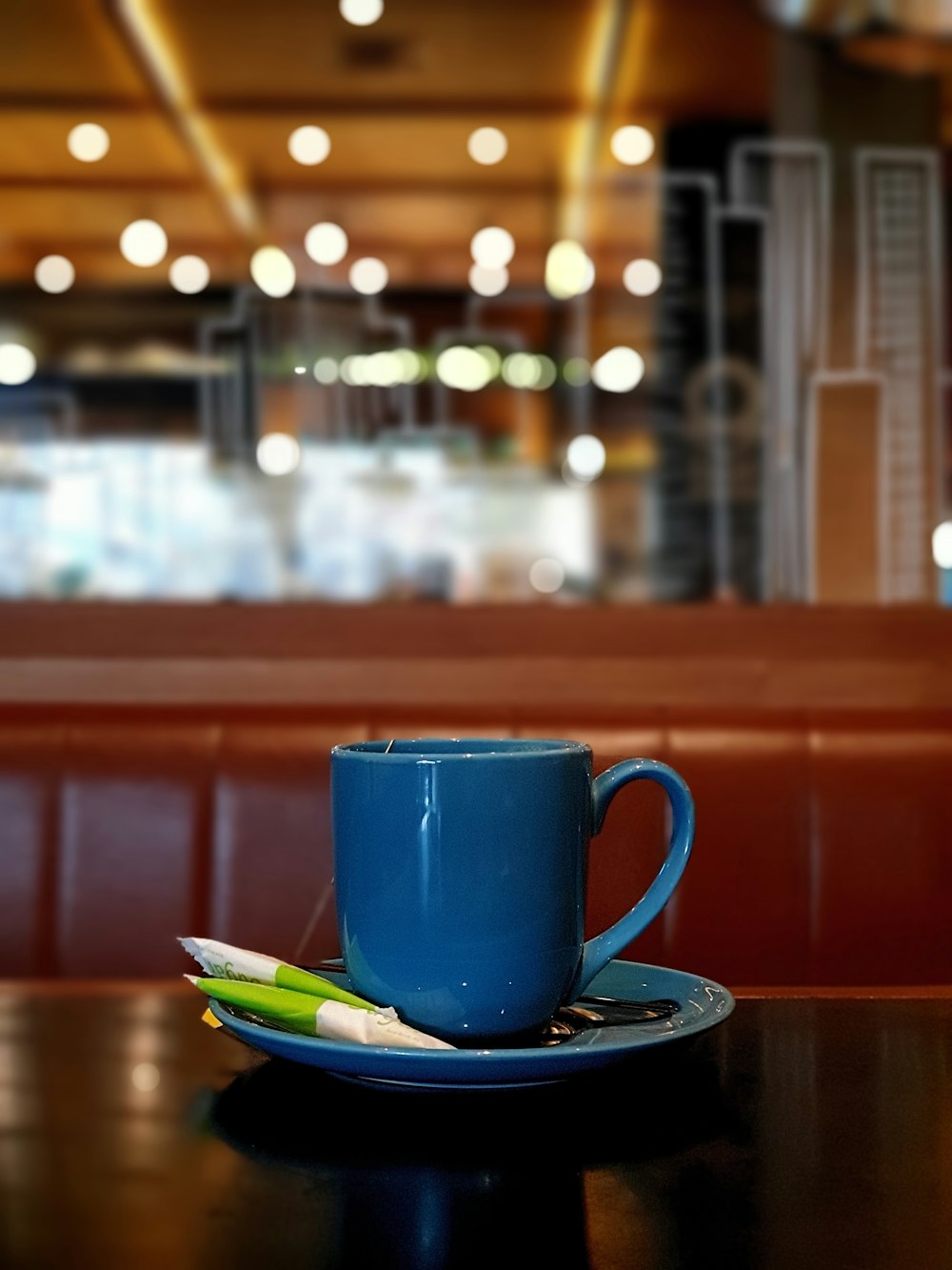 a blue cup sitting on top of a wooden table