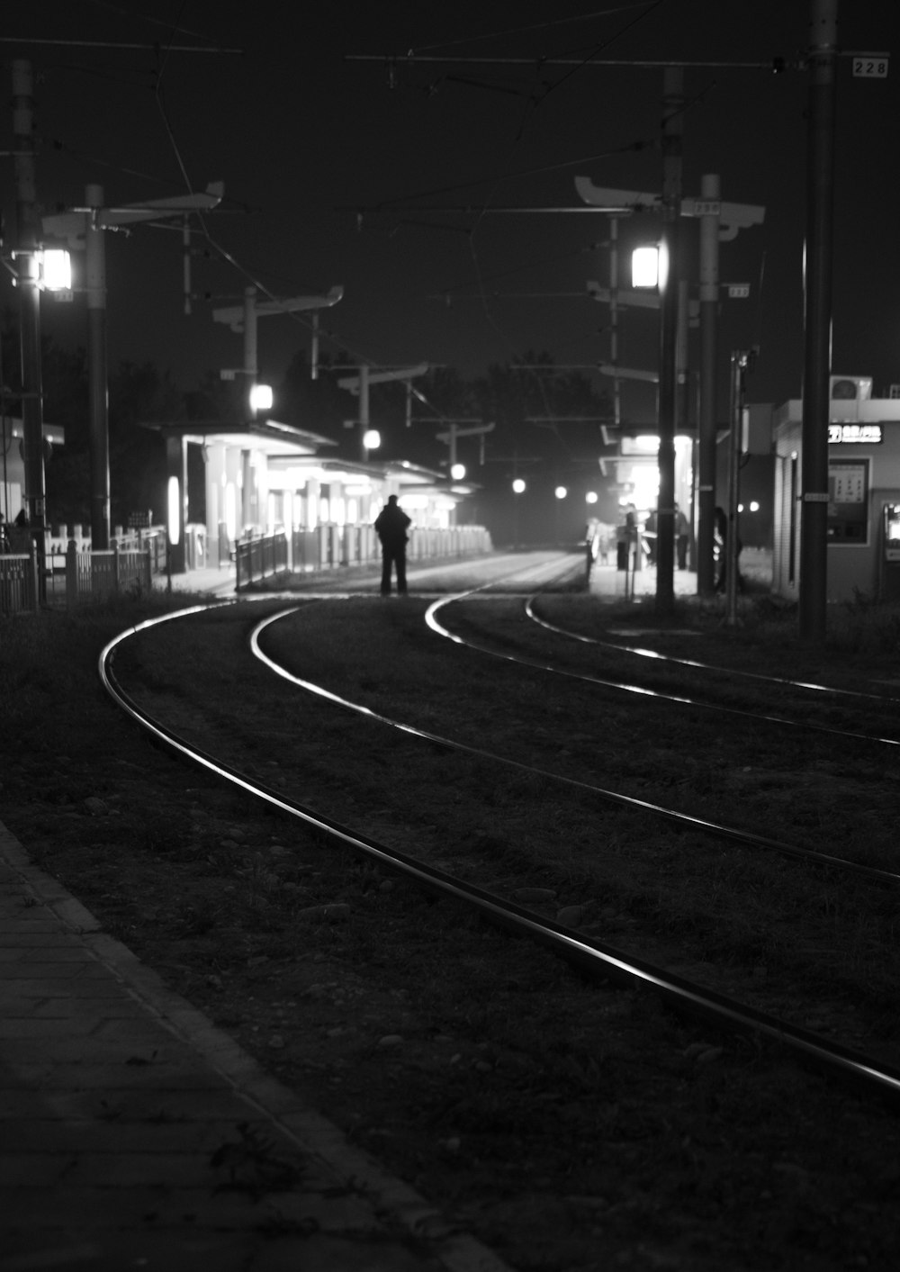 a person standing on a train track at night