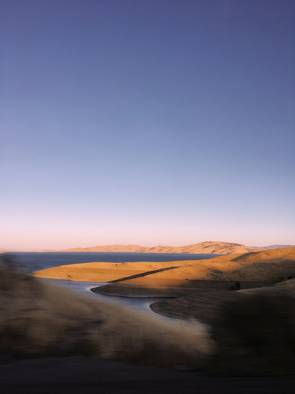 a view of a body of water from a moving vehicle