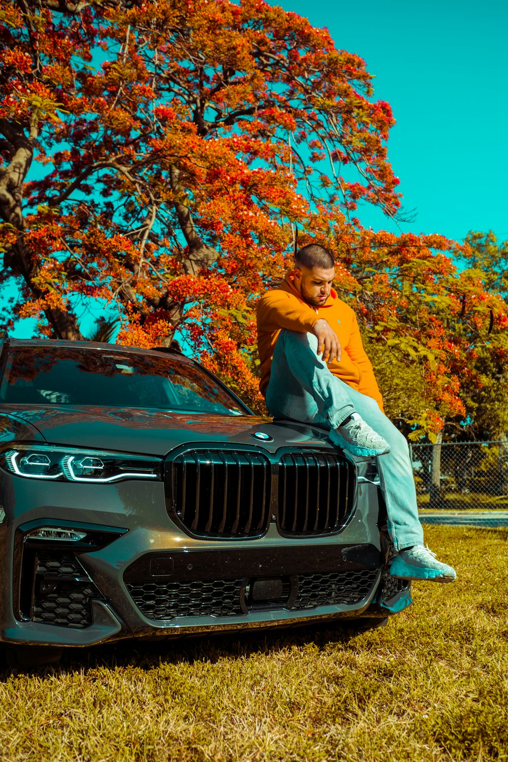 a man sitting on the hood of a car