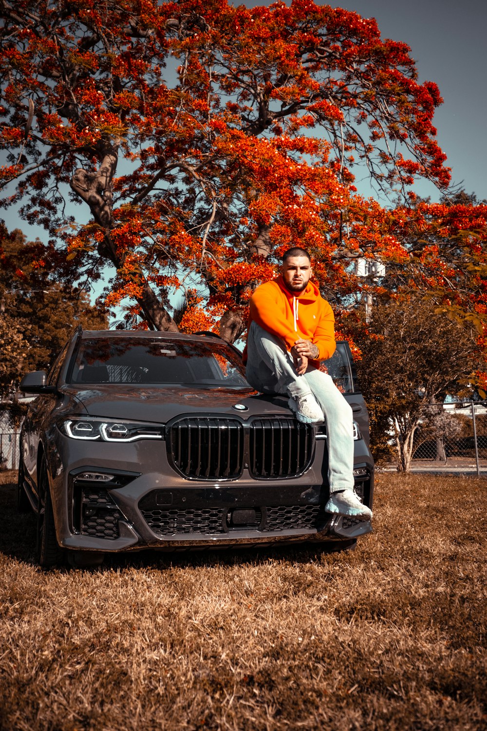 a man sitting on the hood of a car