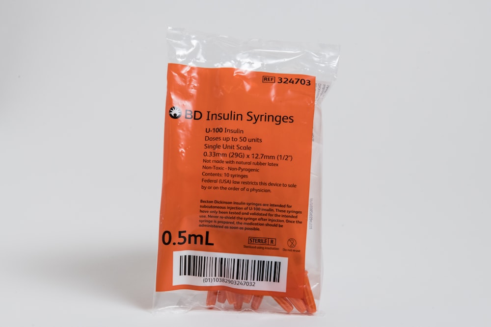 a package of orange string strings on a white background