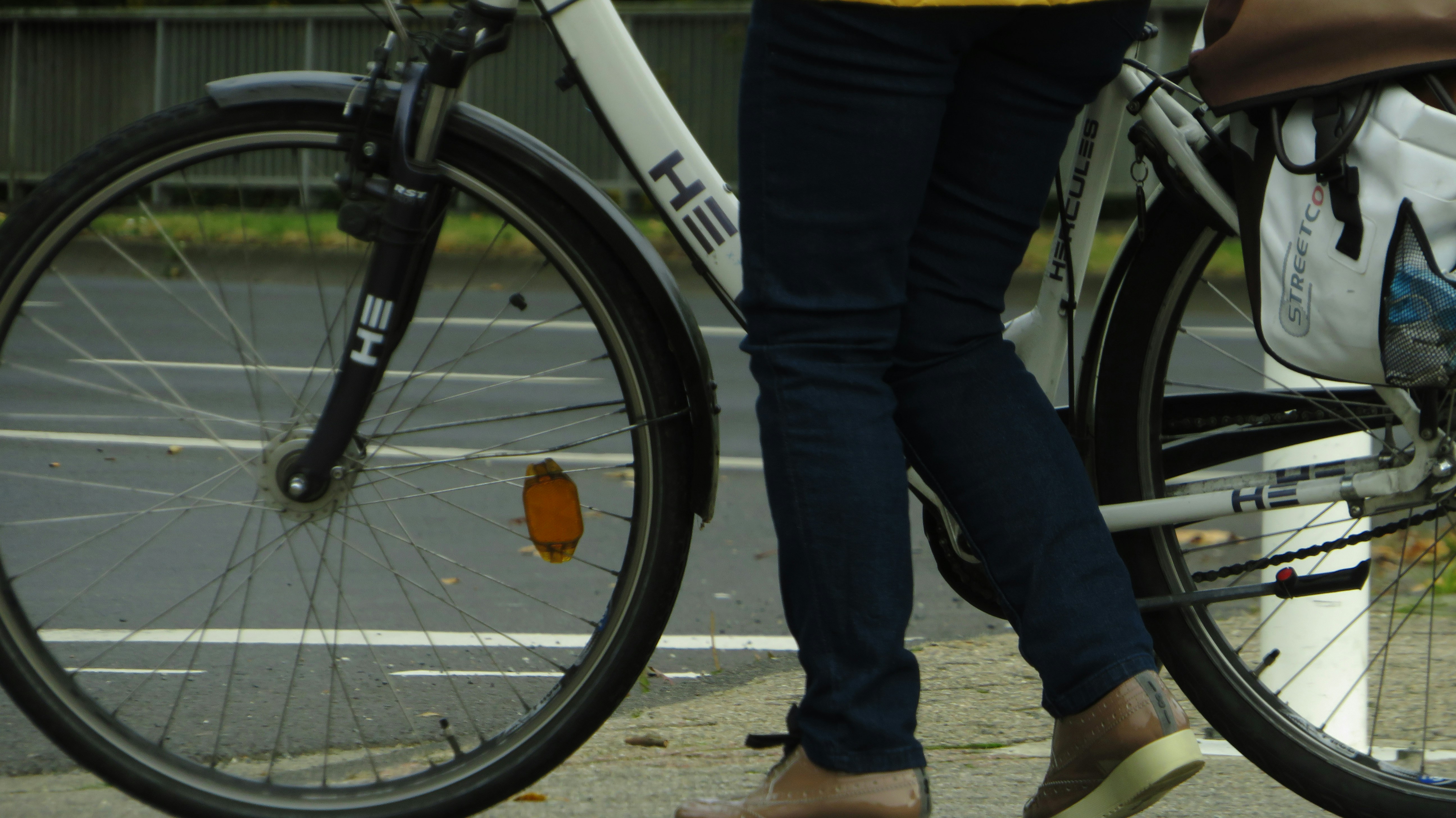 a close up of a person walking a bike