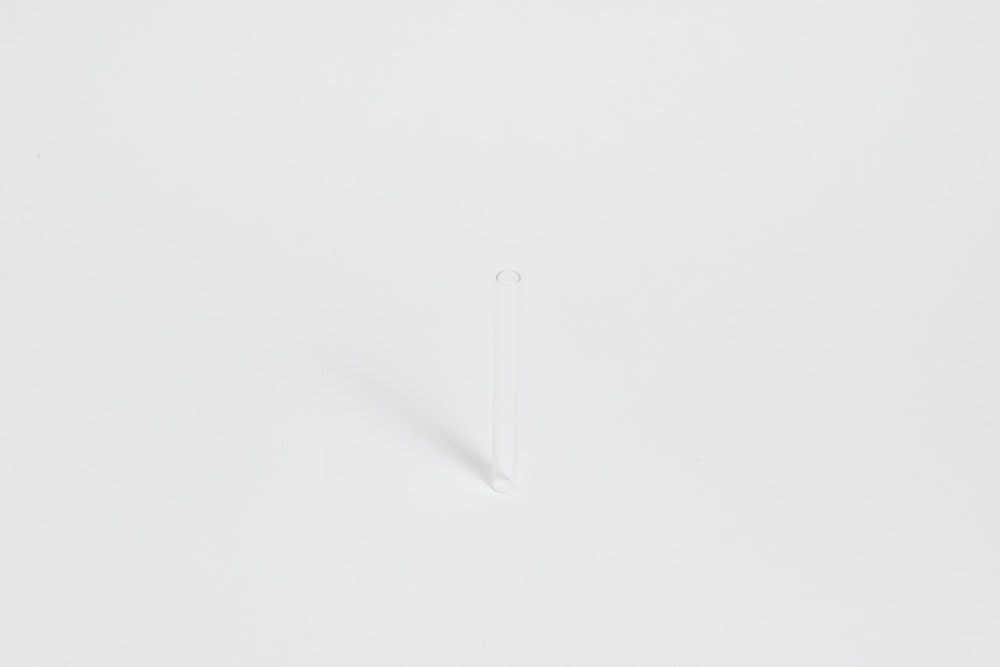 a white wall with a small white object on it