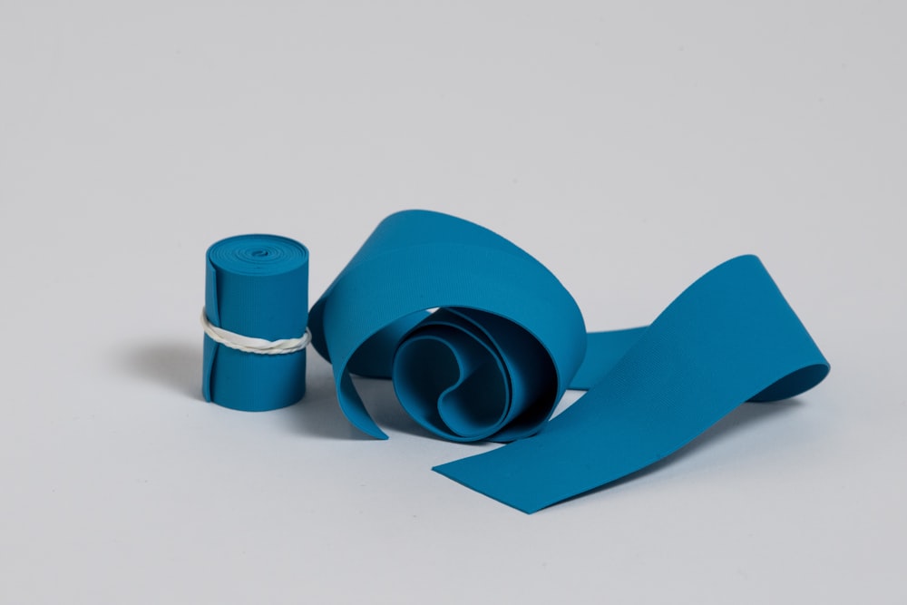 Un rollo de papel azul junto a un rollo de cinta azul