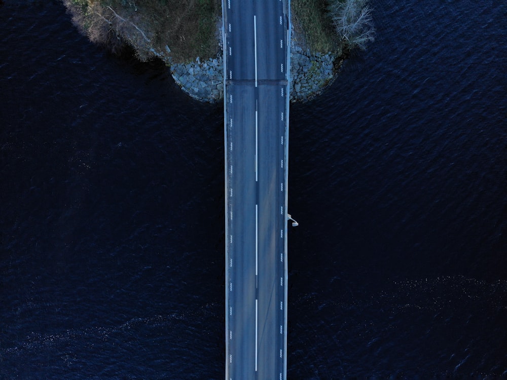 an aerial view of a road over a body of water