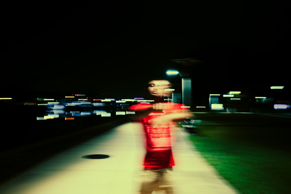 a blurry photo of a person standing on a sidewalk