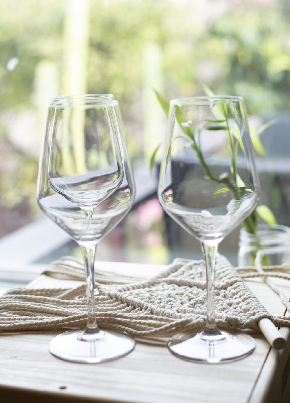 a couple of wine glasses sitting on top of a wooden table