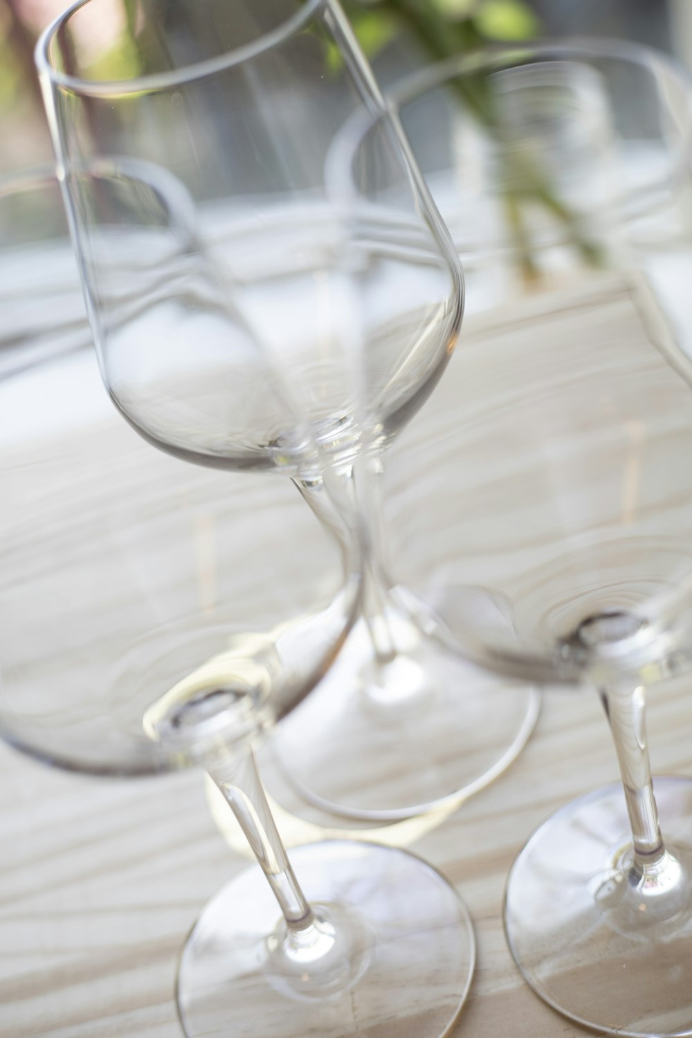 three empty wine glasses sitting on a table