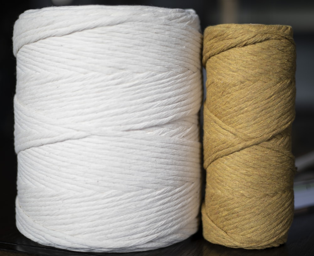 two skeins of yarn sitting on a table