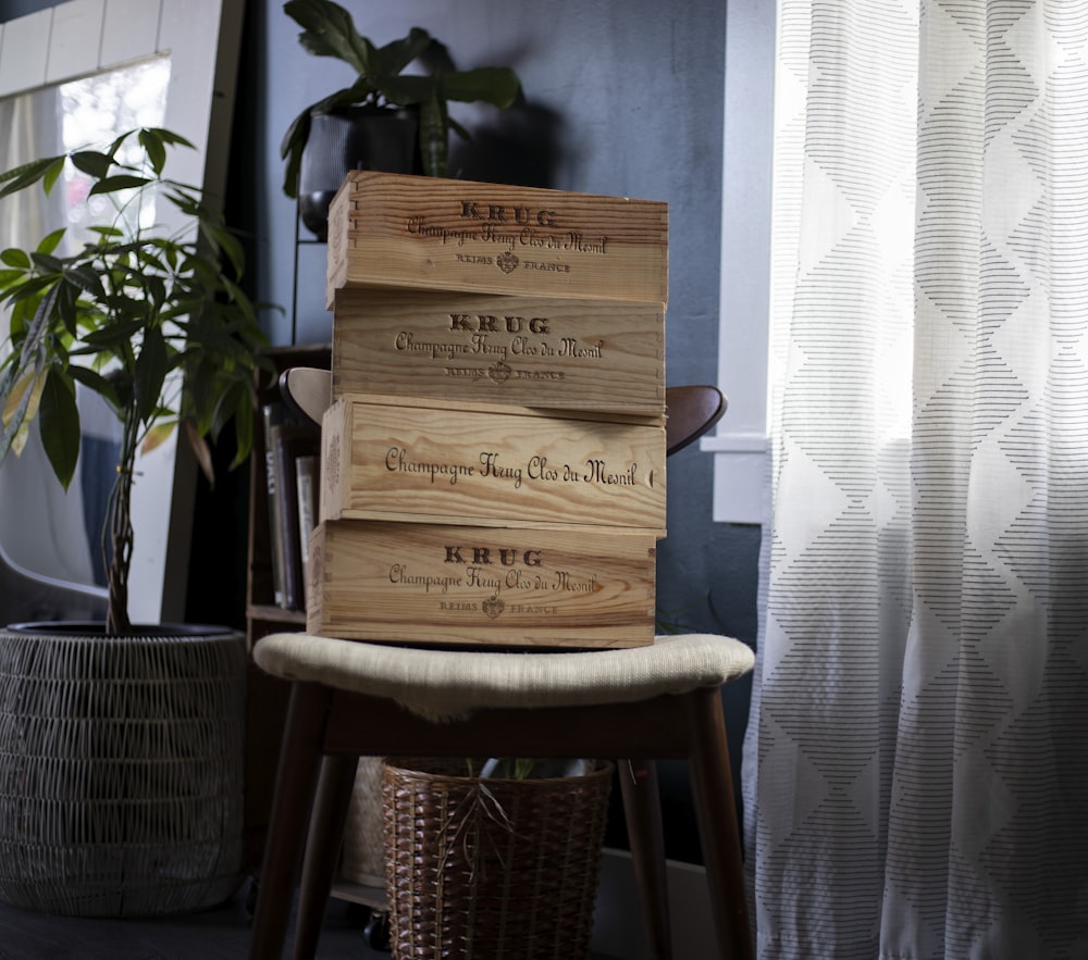 a stack of wooden crates sitting on top of a chair