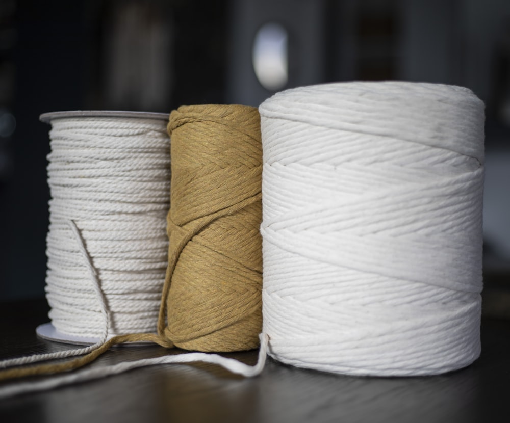 three spools of twine are sitting on a table