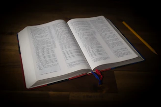 an open book sitting on top of a wooden table