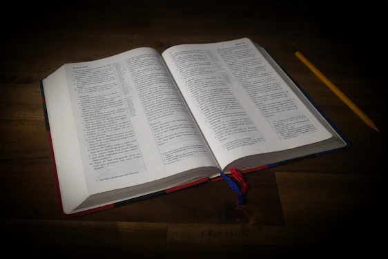 an open book sitting on top of a wooden table