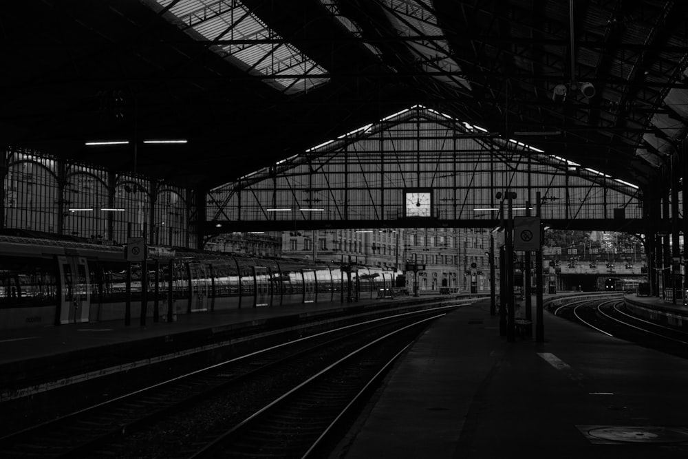 a black and white photo of a train station