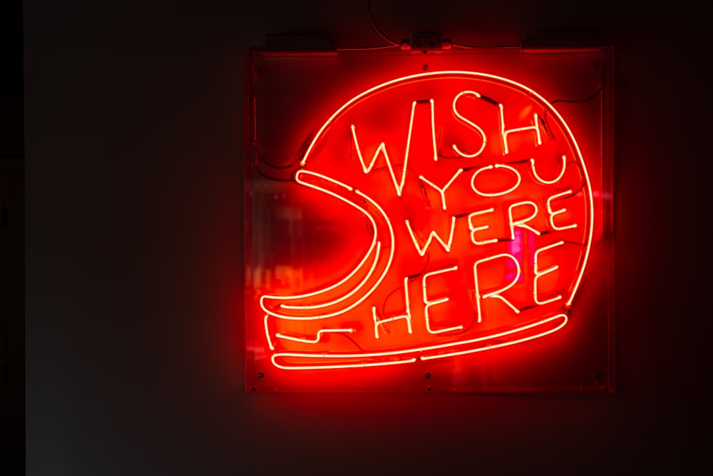 a neon sign that says wish you were here