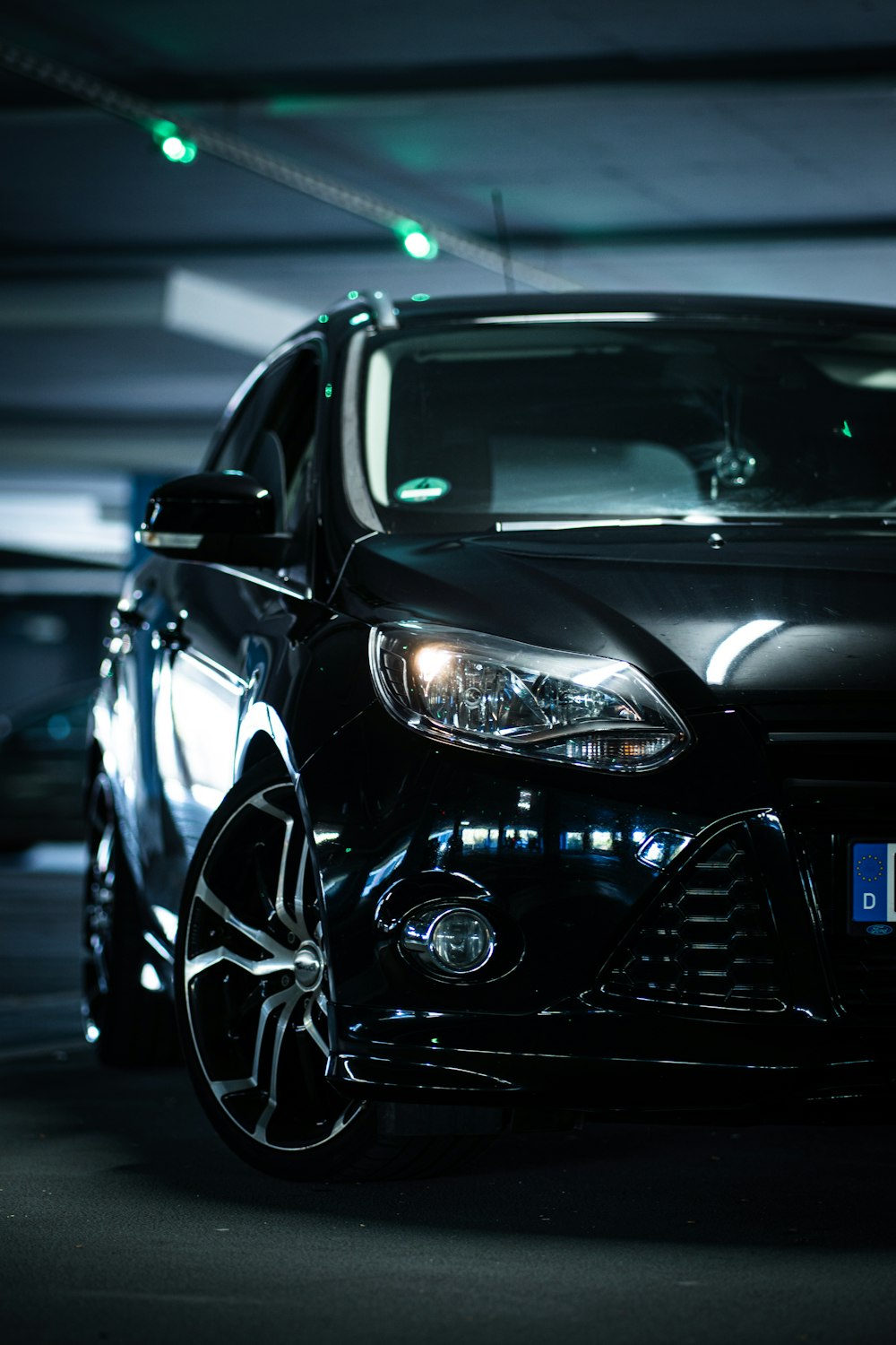 a black car parked in a parking garage