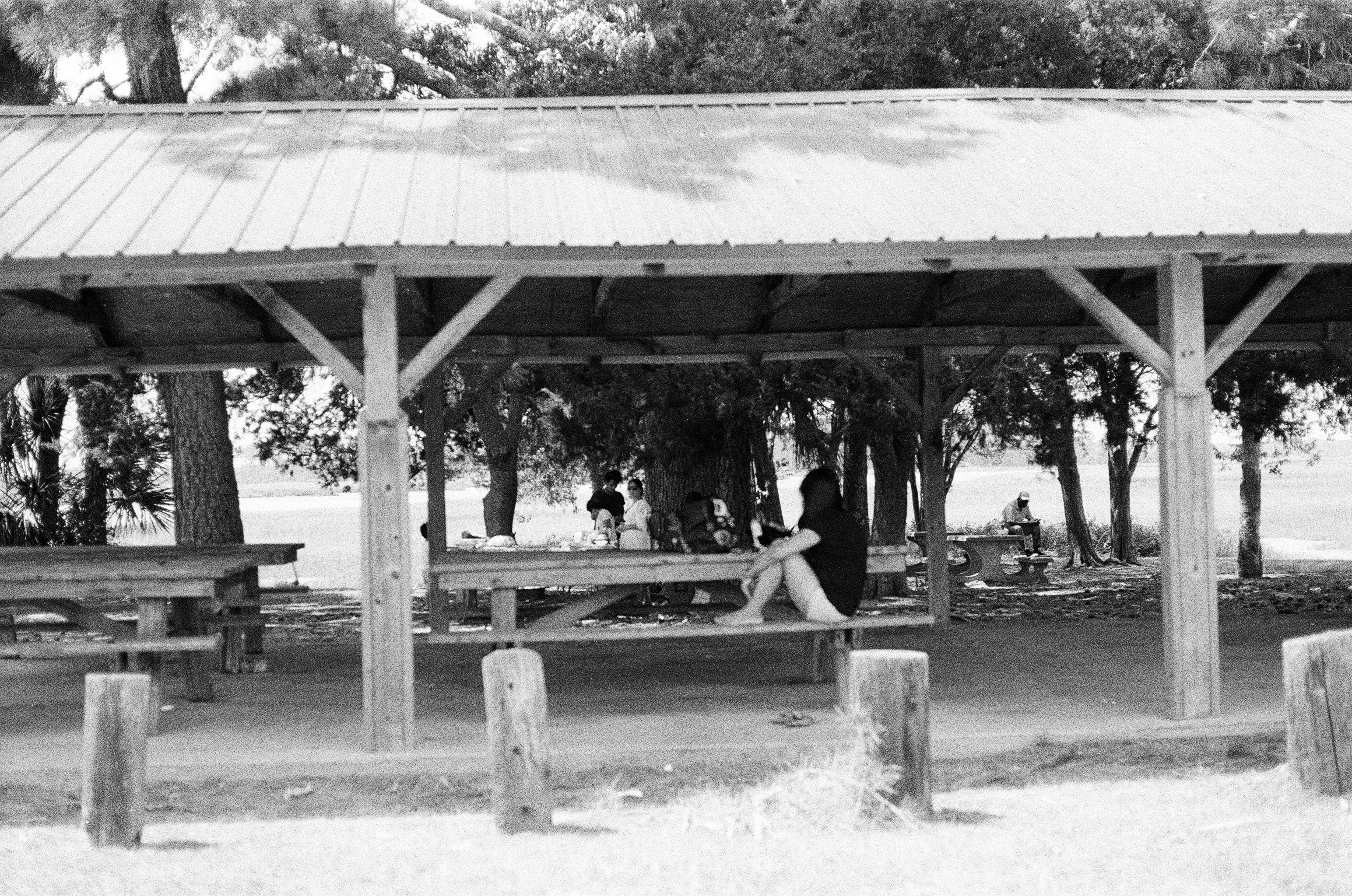 Black and white photo of person on bench