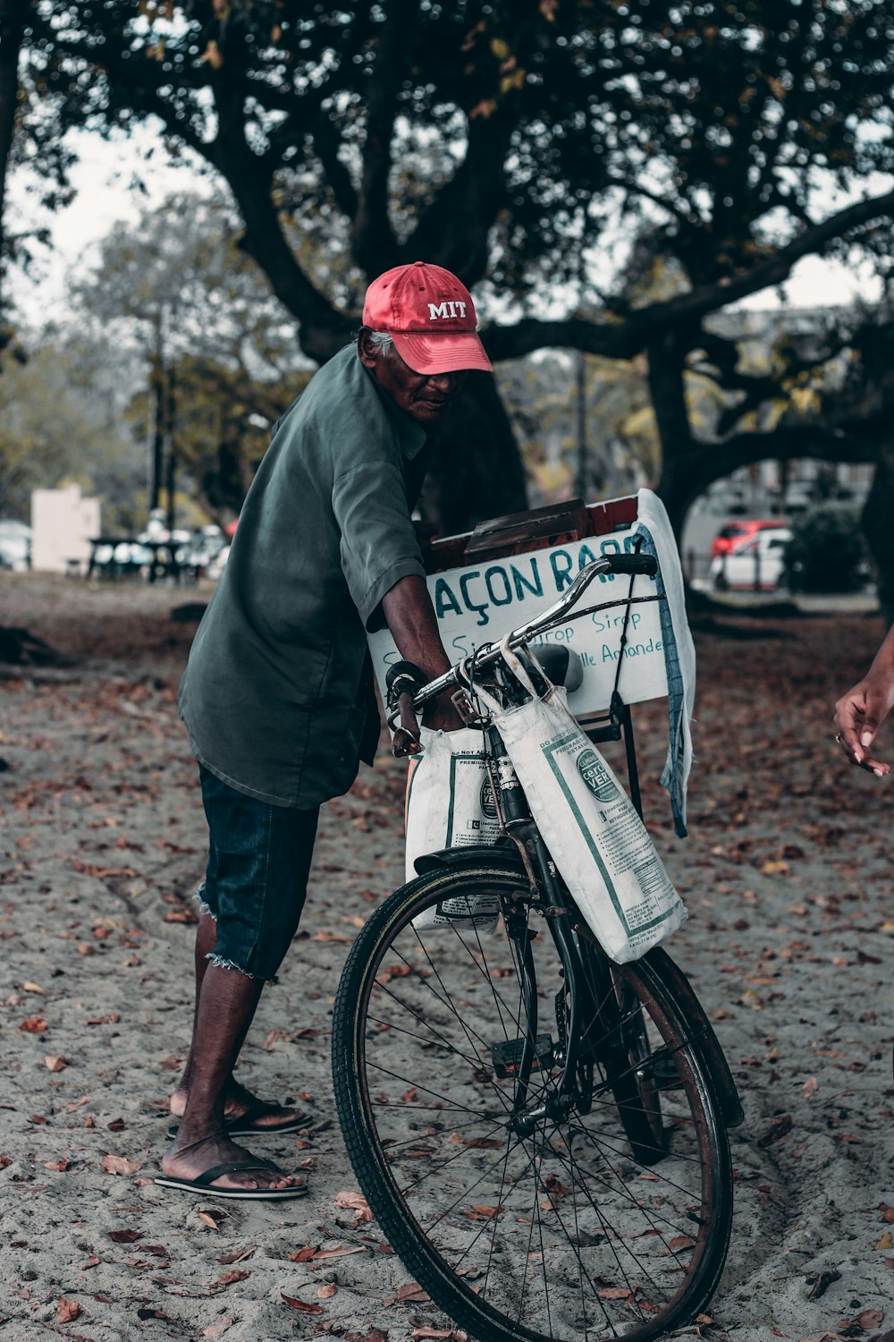 a man standing next to a bike with a newspaper strapped to it