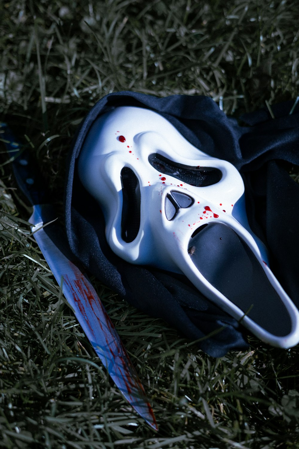 a white mask laying on top of a black bag