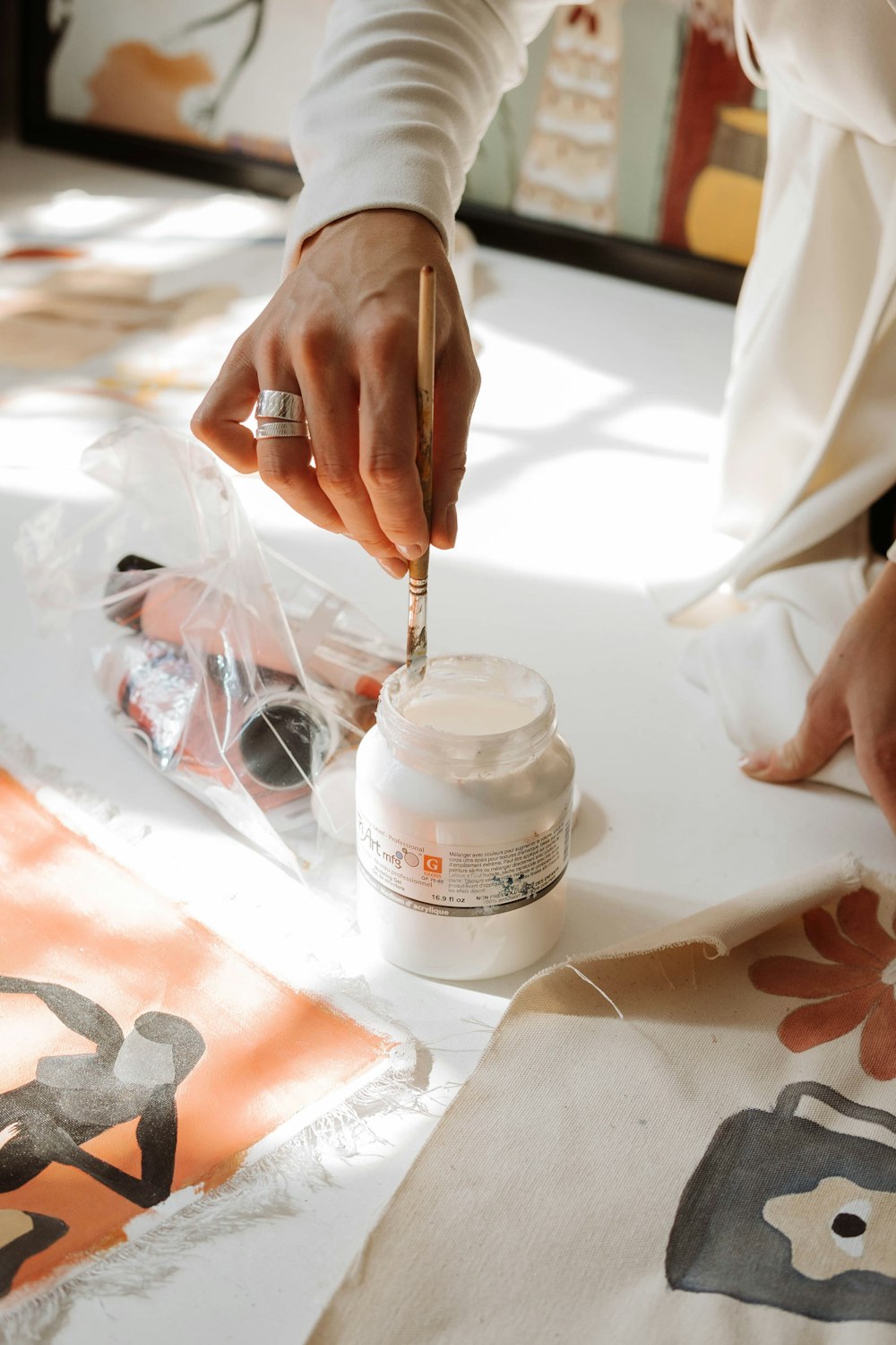 a person is painting a picture on a table