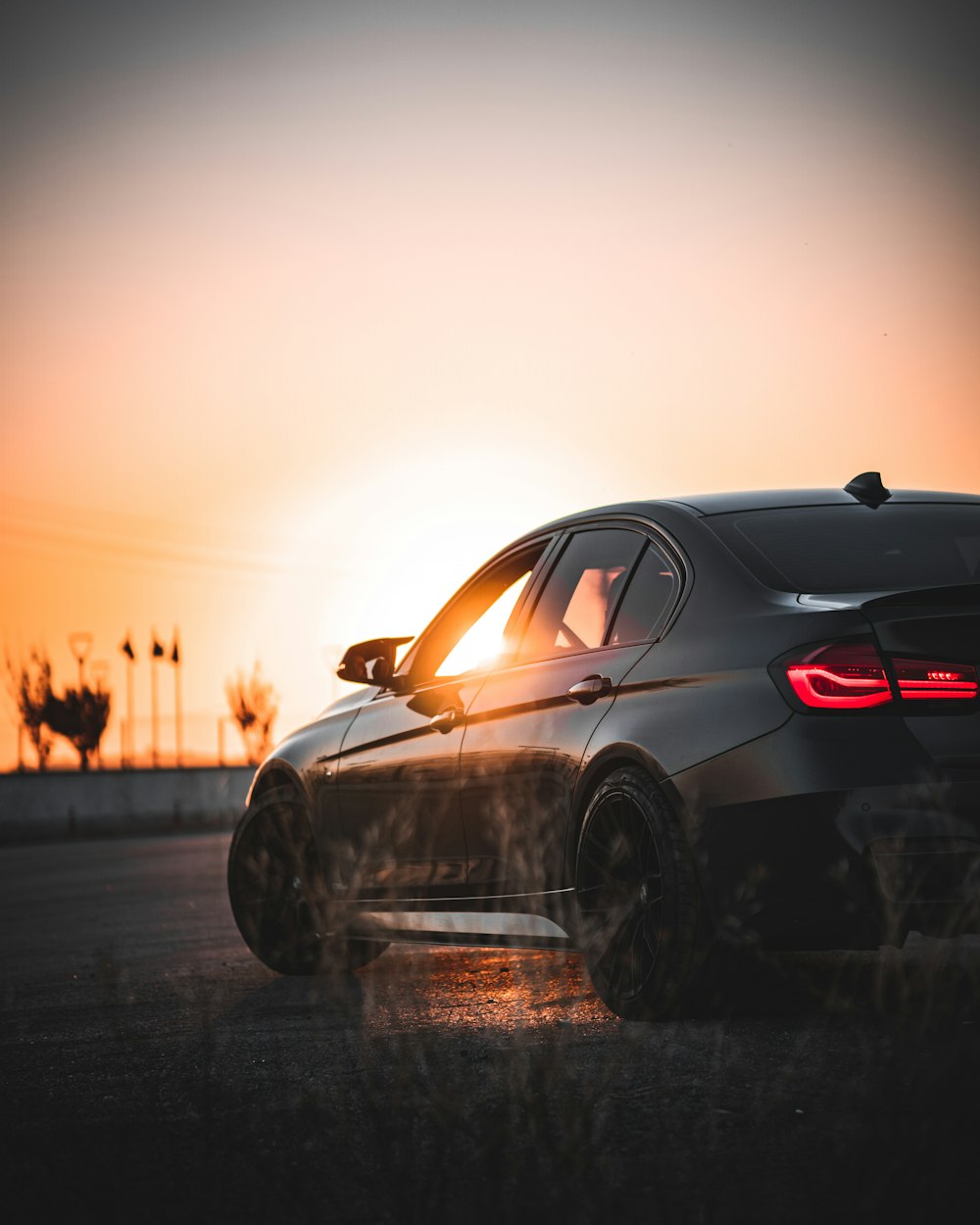 a car parked in a parking lot at sunset