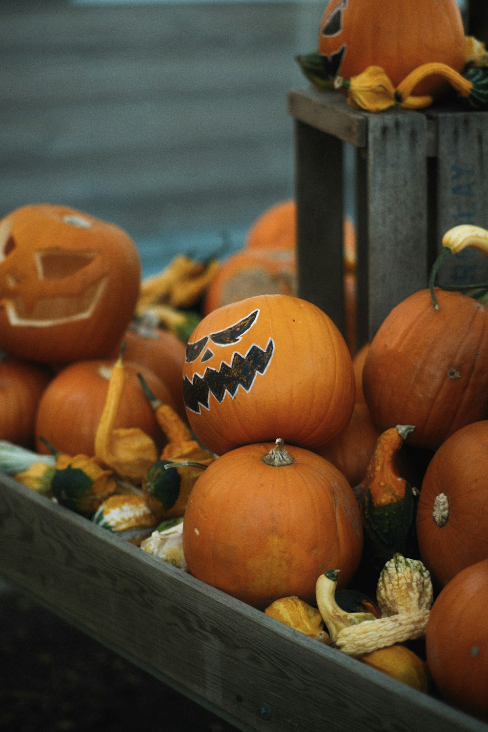 a wooden crate filled with lots of pumpkins