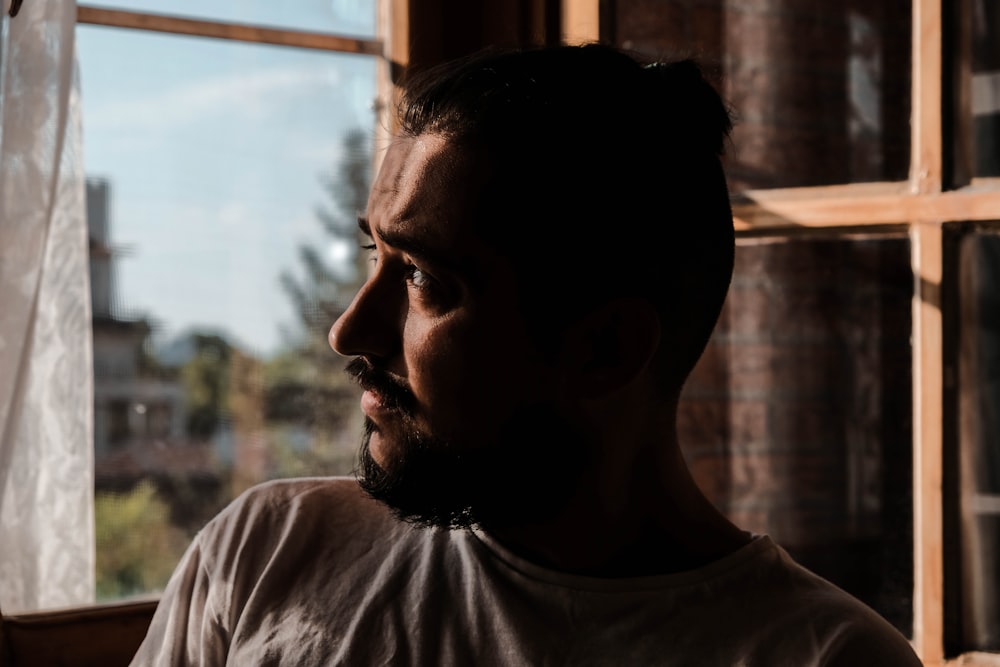 a man looking out of a window in a building