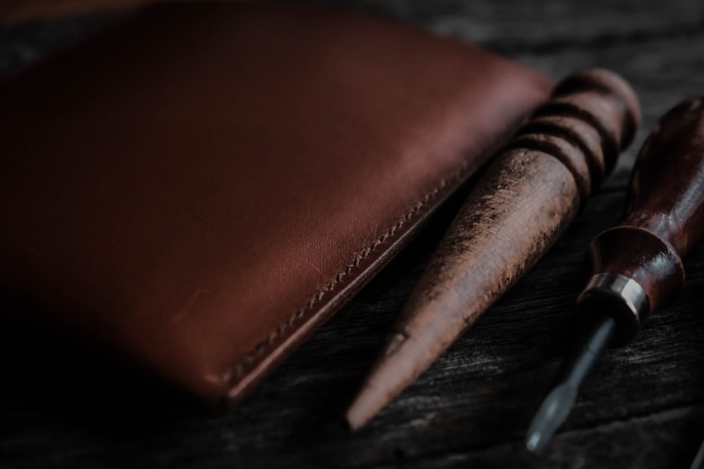 a pen and a wallet sitting on a table