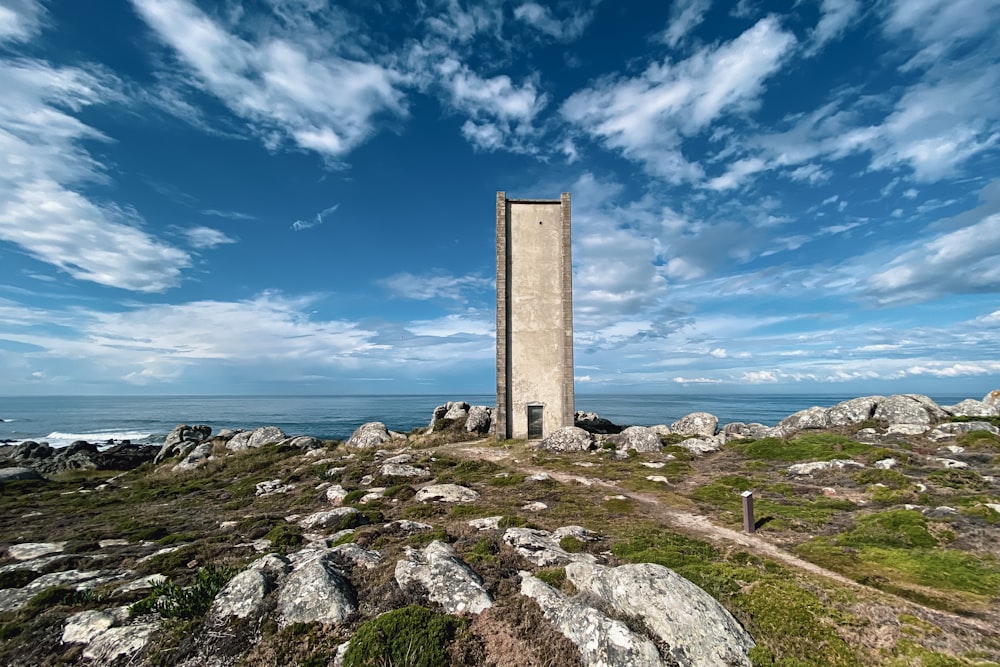 a tall tower sitting on top of a lush green hillside