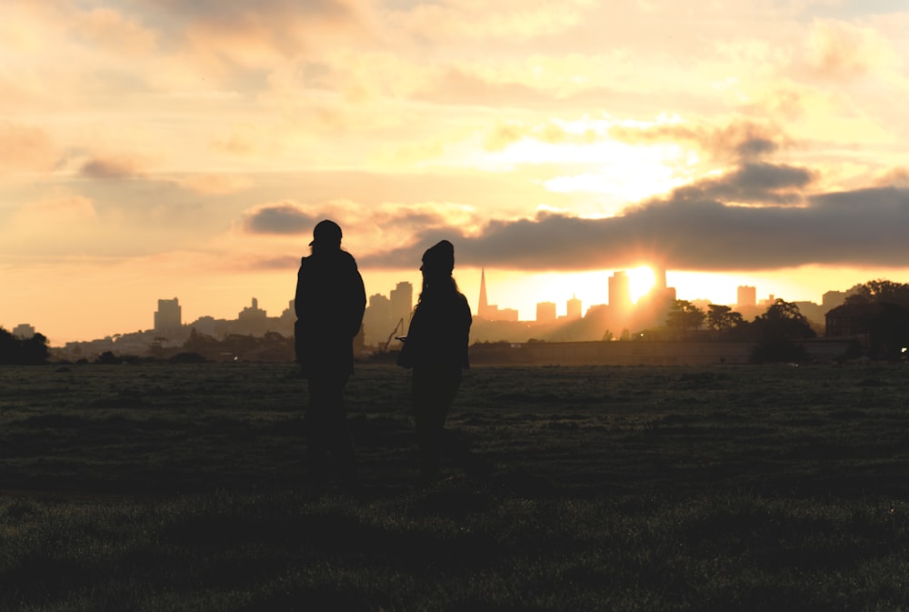 a couple of people standing in a field