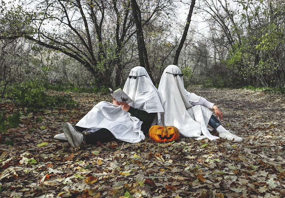 a group of three people dressed up as ghostes