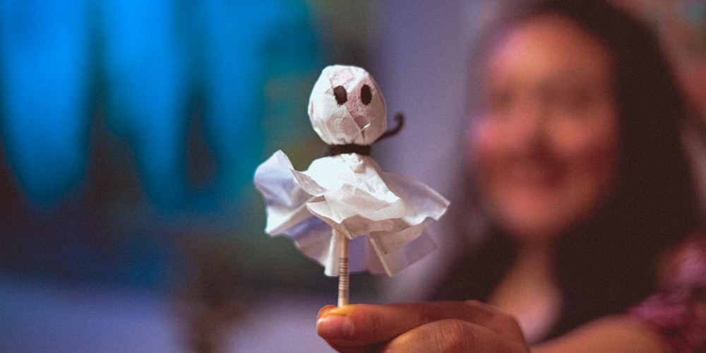 a close up of a person holding a toy