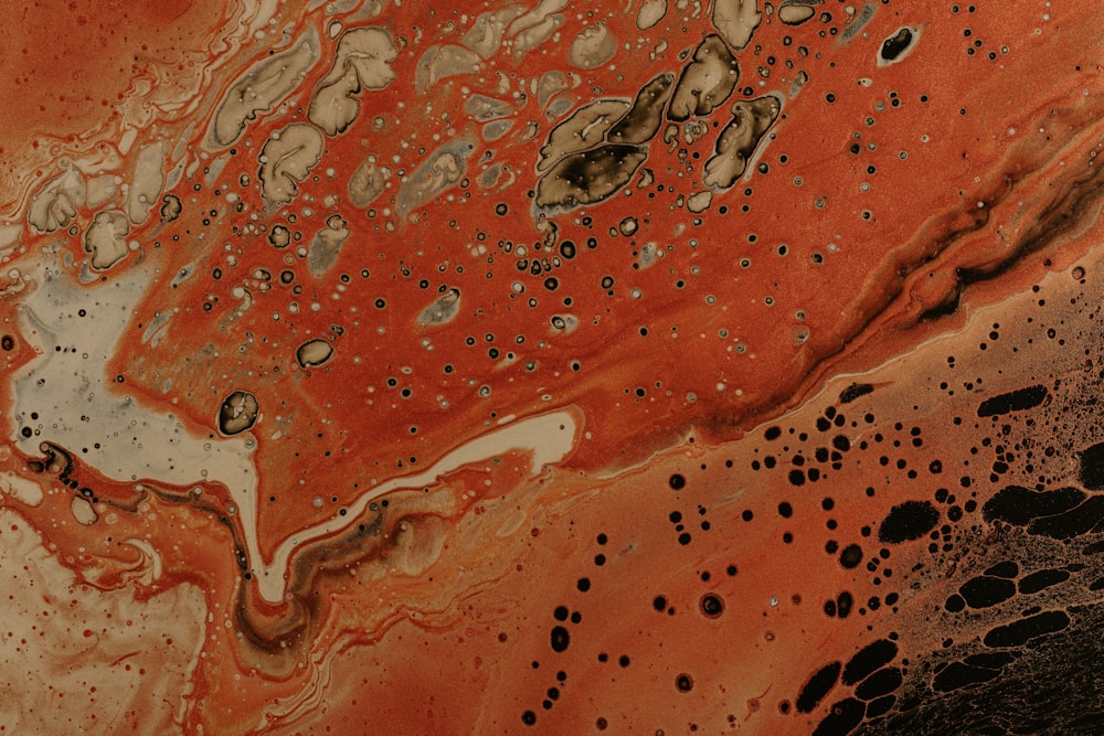 a close up of an orange and black substance
