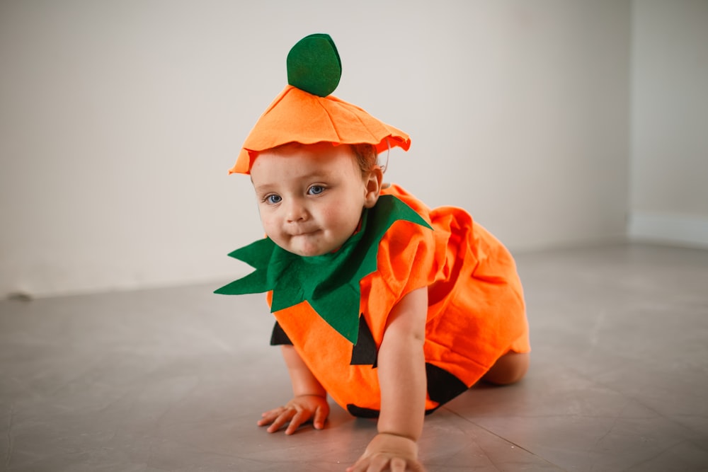 A baby dressed in a carrot costume crawling on the floor photo – Free  Apparel Image on Unsplash
