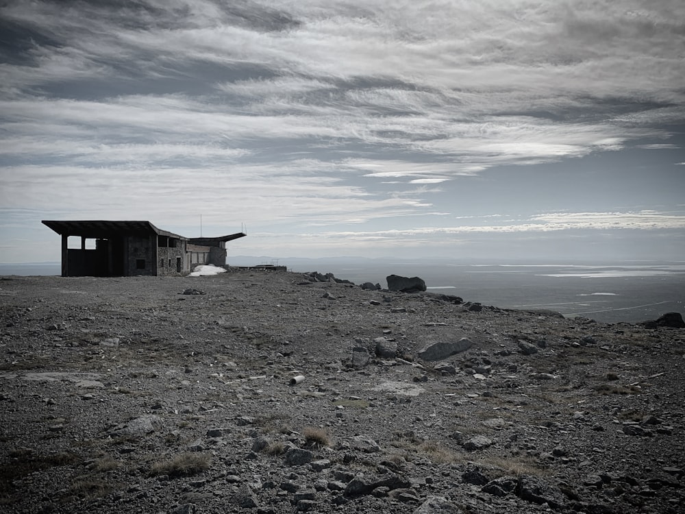 a small building sitting on top of a rocky hill