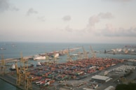 An aerial view of a bustling port with shipping containers.