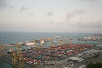 Aerial view of a busy port with containers and ships.