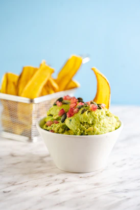 a bowl filled with guacamole and chips