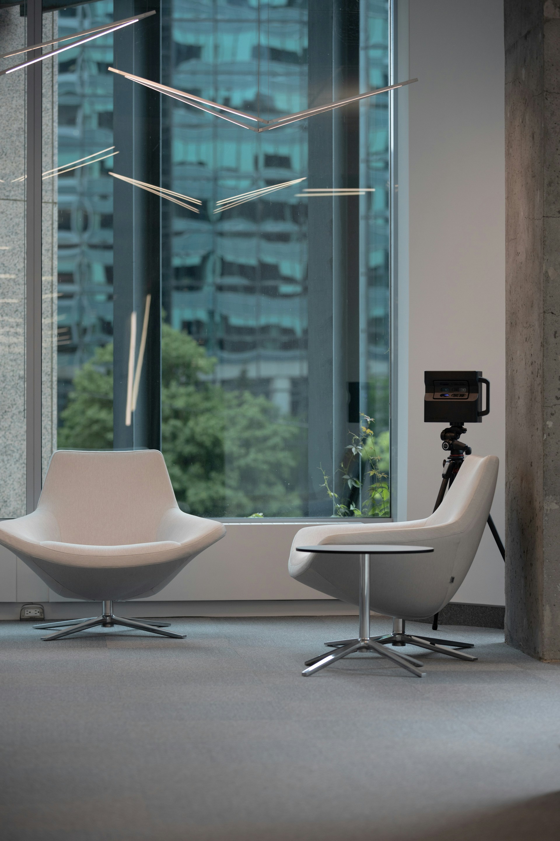 a room with a chair, a chair and a camera in it