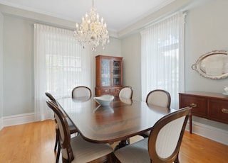 a dining room table with chairs and a china cabinet